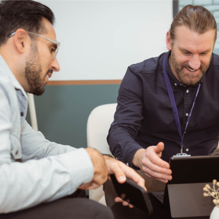 Br One Consulting founders collaborating on a digital transformation strategy to improve user adoption.